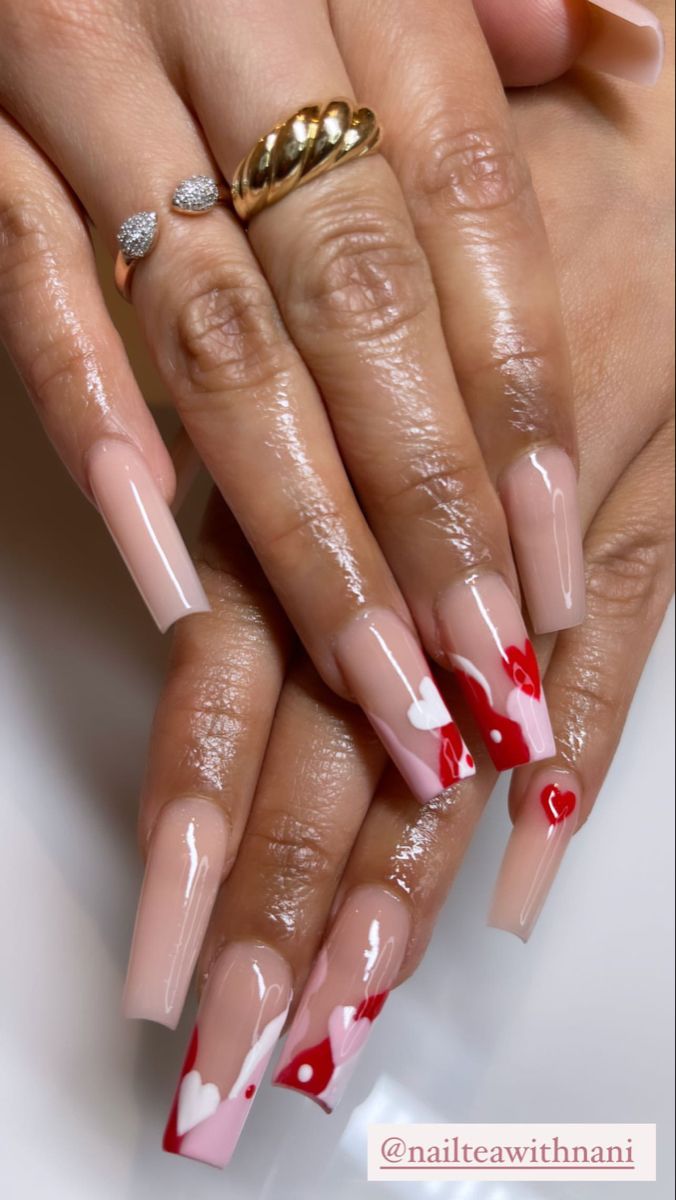 Chic Nail Art: Nude Base with Vibrant Red and Pink Heart Designs for Romantic Elegance.