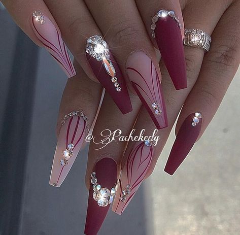 Chic Stiletto Nail Design: Deep Burgundy and Soft Pink with Intricate Line Work and Rhinestones.