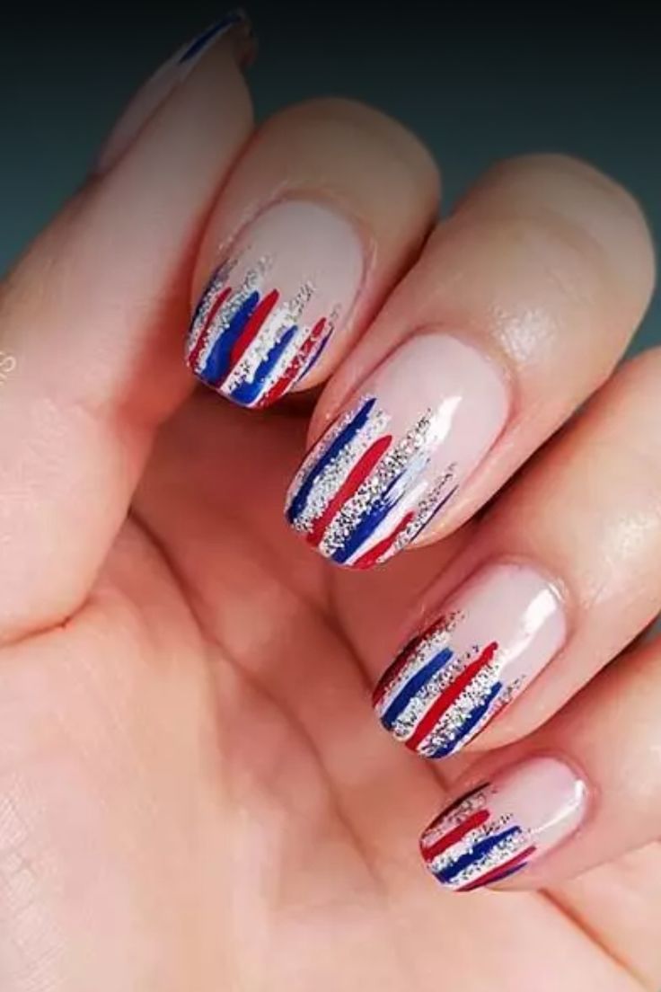 Striking and Sophisticated Colorful Nail Design with Red, Blue, and Shimmering Silver Stripes.