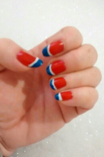 Vibrant Red and Blue Nail Design with Unique Patterns and Striking White Stripes.