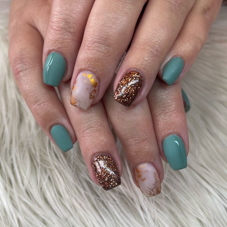 Chic Matte Teal and Shimmering Gold Nail Design with Glitter and Marble Accents