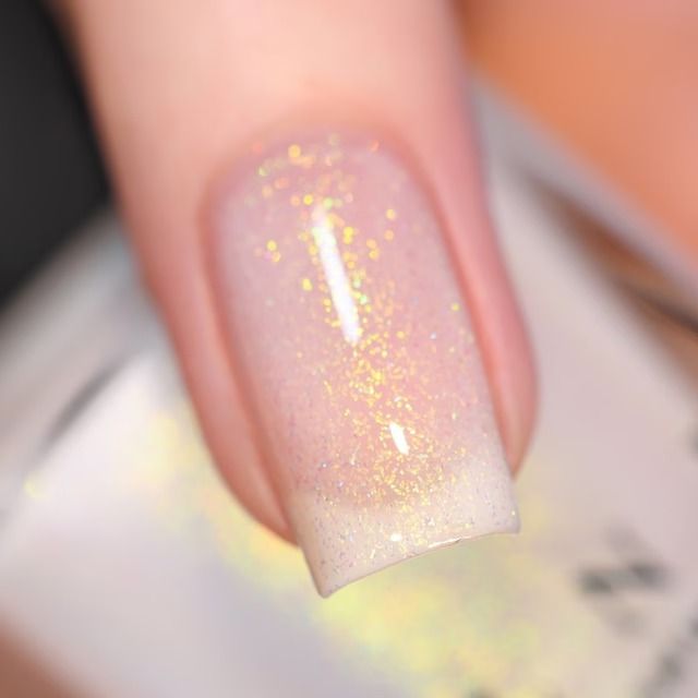 Elegant Glittery Ombre Nail Design with Pastel Base and Iridescent Sparkle.