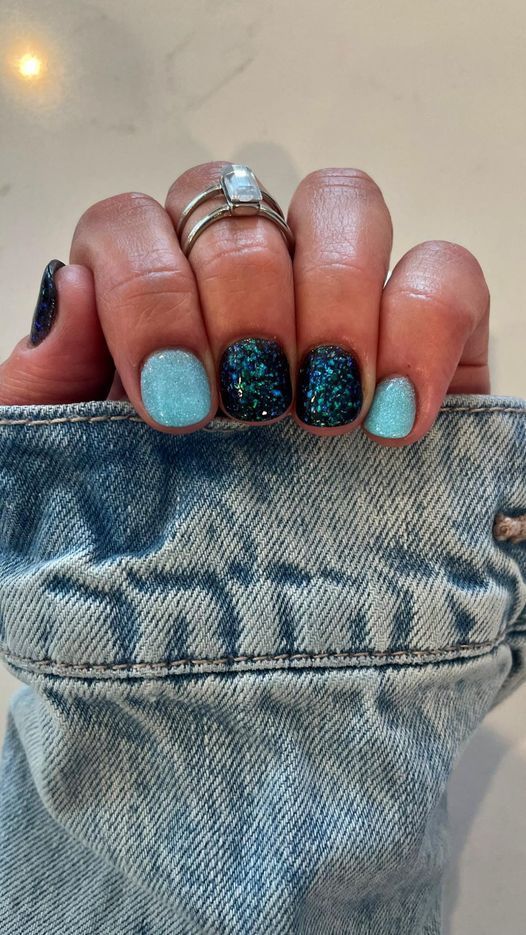 Vibrant Nail Design: Soft Blue Meets Glittery Dark Shade for an Eye-Catching Look