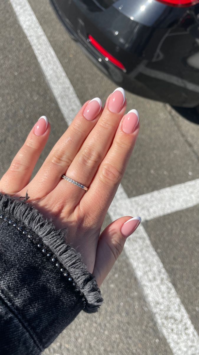 Classic French Manicure: Elegant Soft Pink Base with White Tips and Glamorous Ring Accent.