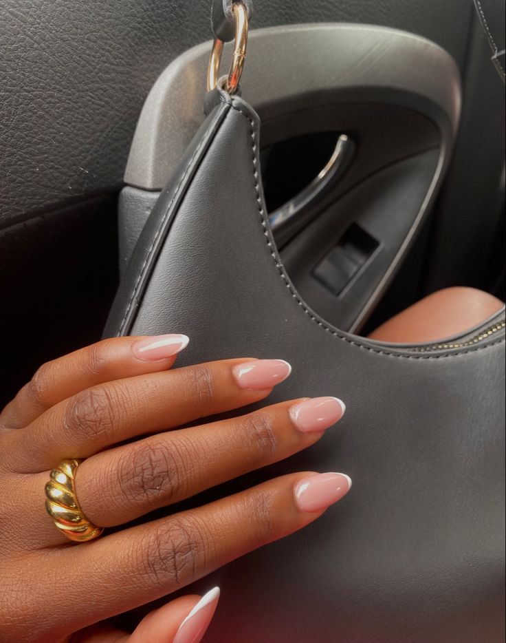 Sophisticated Almond-Shaped Manicure: Elegant Nude Base with Classic White Tips and Glamorous Gold Accent.