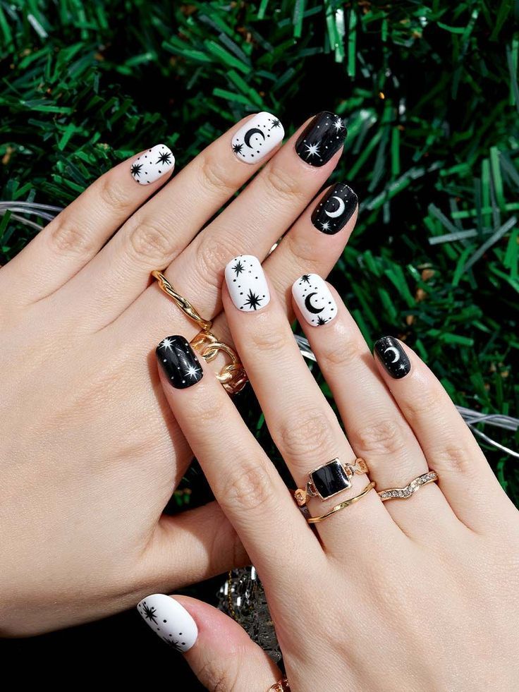 Chic Black and White Celestial Nail Design with Gold Accents