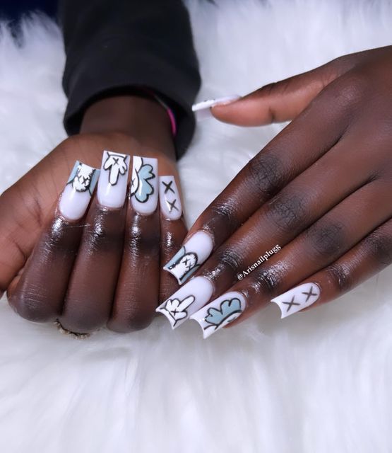 Whimsical Almond-Shaped Nail Art with Hand-Drawn Clouds and Floral Motifs in Soft White, Blue, and Black.