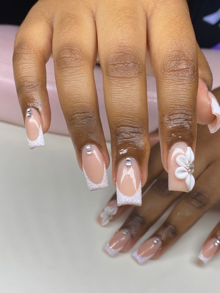 Elegant Floral Nude Nail Design with White Tips and Rhinestones