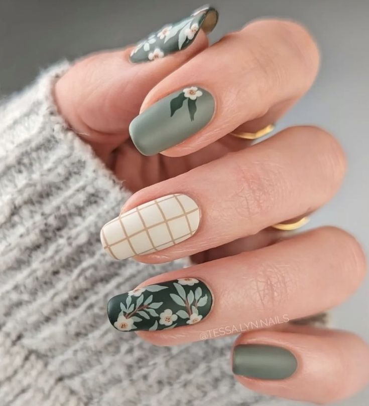 Chic Nail Design: Matte Finish Meets Intricate Floral and Geometric Patterns in Muted Greens.