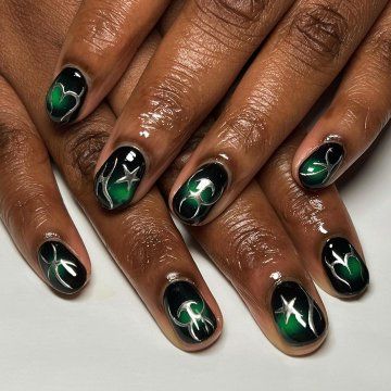 Elegant Abstract Green and Black Nail Design with Glossy Finish and Intricate Detailing.