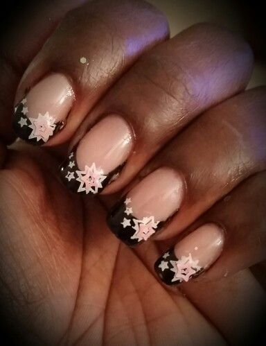 Sophisticated Soft Pink and Bold Black French Tip Nail Art with Floral and Star Accents