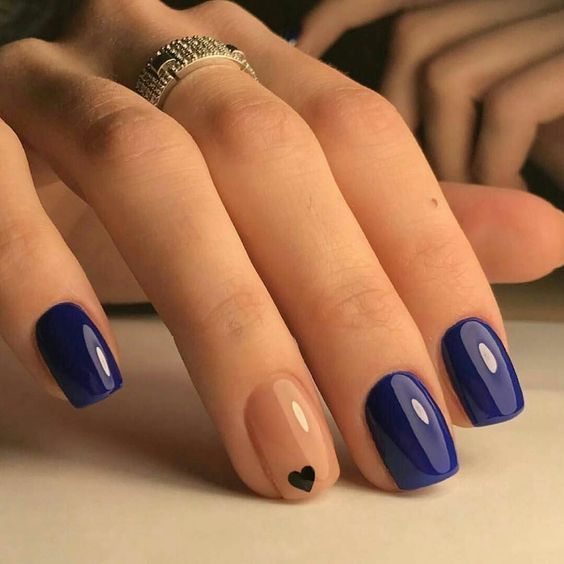 Chic Vibrant Blue Nail Design with Glossy, Matte Finishes and Playful Nude Heart Accent.