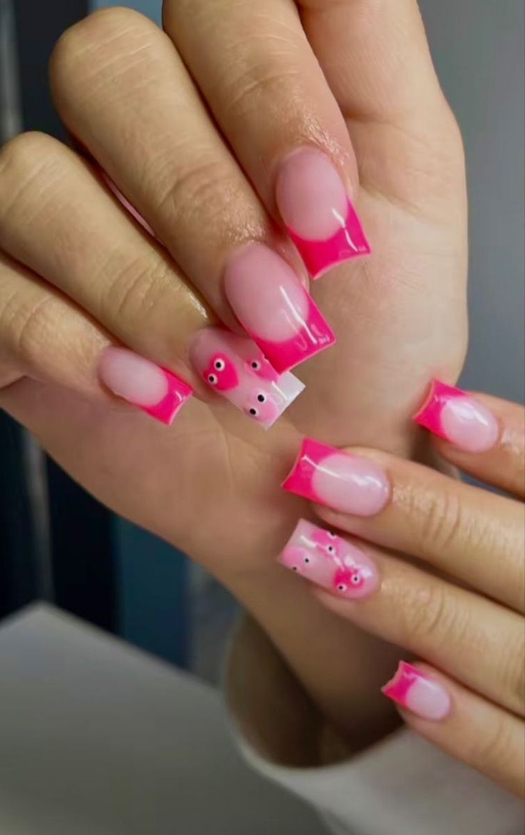 Playful Pink French Tip Nails with Whimsical Motifs for a Lively Manicure.