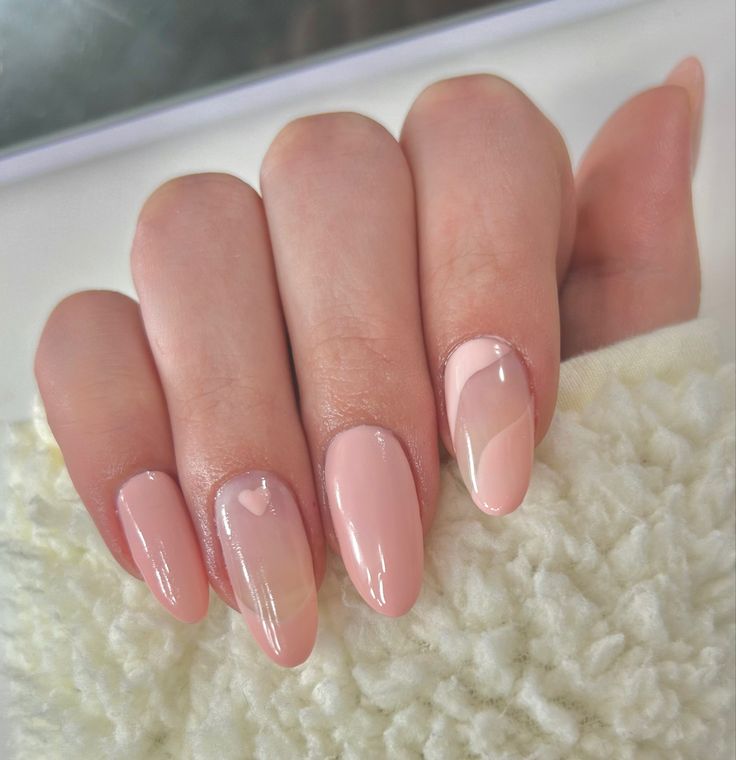 Elegant Nude Pink Nail Design with Playful Heart Accents