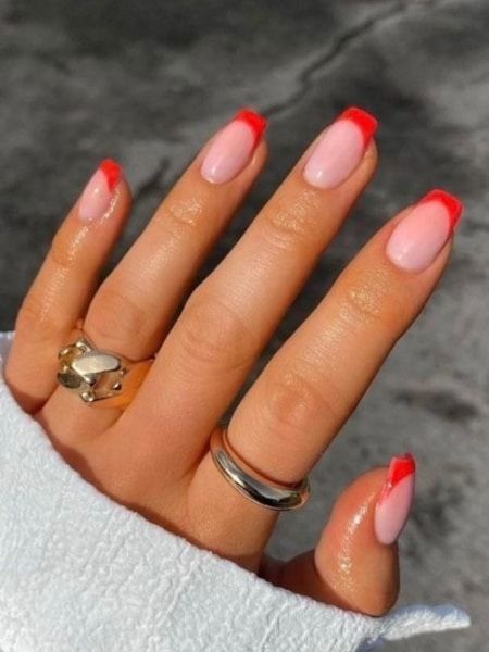 Chic Pink and Red French Manicure with Delicate Ring Accents.