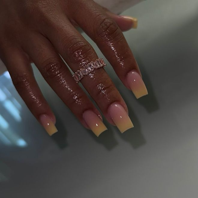 Chic Gradient Nail Design: Soft Pink to Vibrant Yellow with Glamorous Touch.