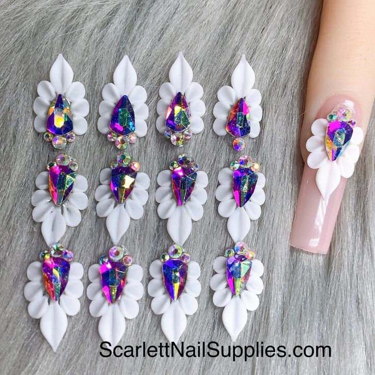 Elegant Floral Nail Design with Vibrant Gemstone Accents for Special Occasions.