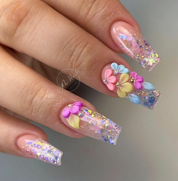 Whimsical Floral Nail Design with Glittery Glamour and Pastel Colors.