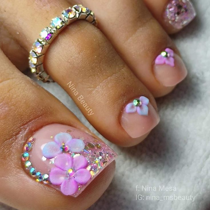 Charming Floral Nail Design with Sparkling Gems and Coordinating Ring