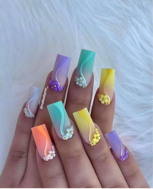 Pastel Ombre Nail Design with Floral Accents: A Modern Elegant Look.