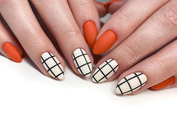 Chic Almond-Shaped Manicure: Matte Orange and Cream with Stylish Black Grid Patterns.