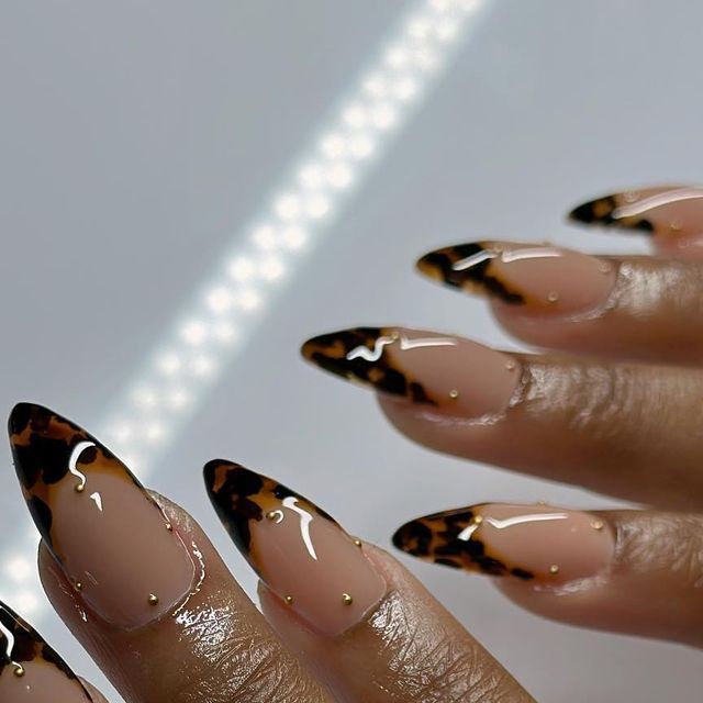 Chic Tortoiseshell Almond Nails with Nude Base and Gold Studs for Timeless Elegance