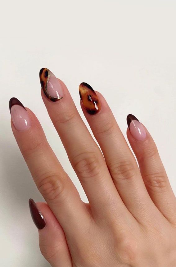 Sophisticated Nail Design: Elegant Nude and Dark Tones with Unique Patterns and Tortoiseshell Effects.