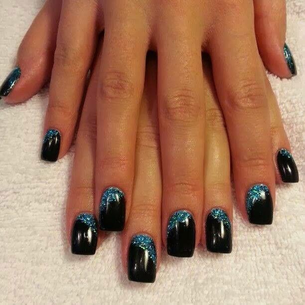 Elegant Black Nail Design with Shimmering Blue Accents and Glitter Gradient.