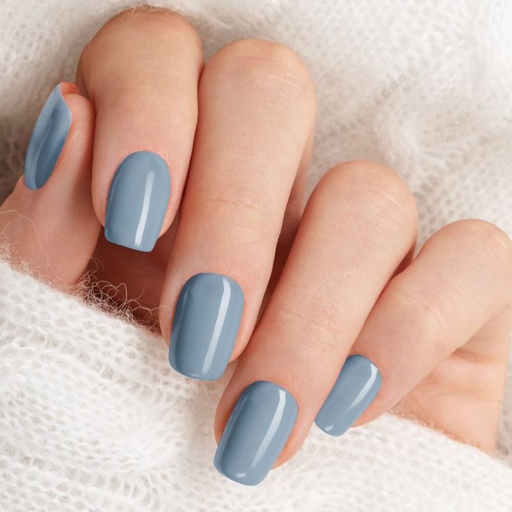 Elegant Glossy Blue Manicure with Cozy Knit Background