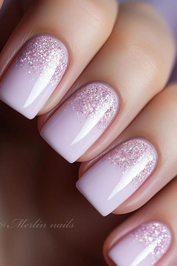 Elegant Gradient Nail Design with Soft Pink Base and Glitter Tips for Glamorous Occasions.