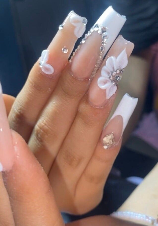 Luxurious Nail Design with Glossy White Tips and Floral Accents