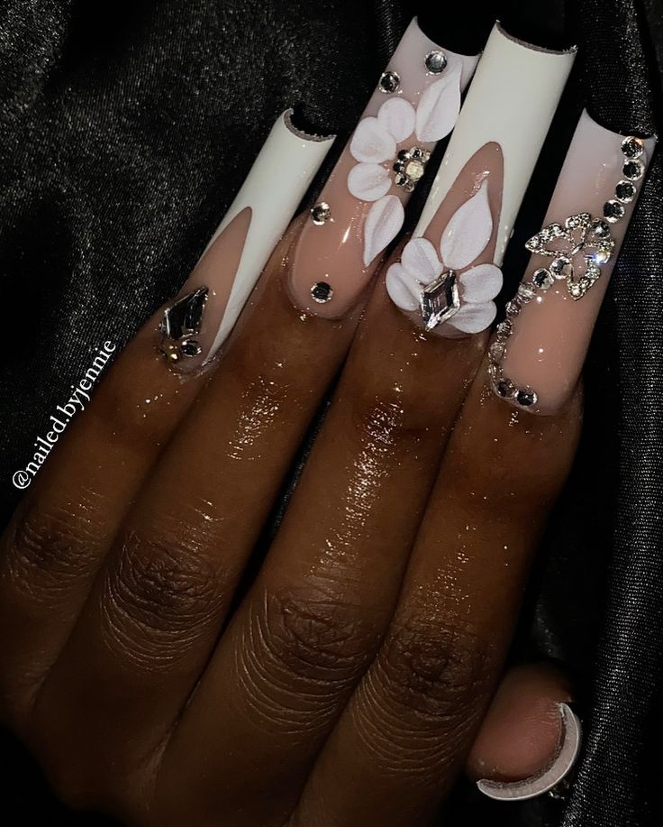 Chic White and Nude Floral Nail Design with Rhinestones for Bold Elegance.