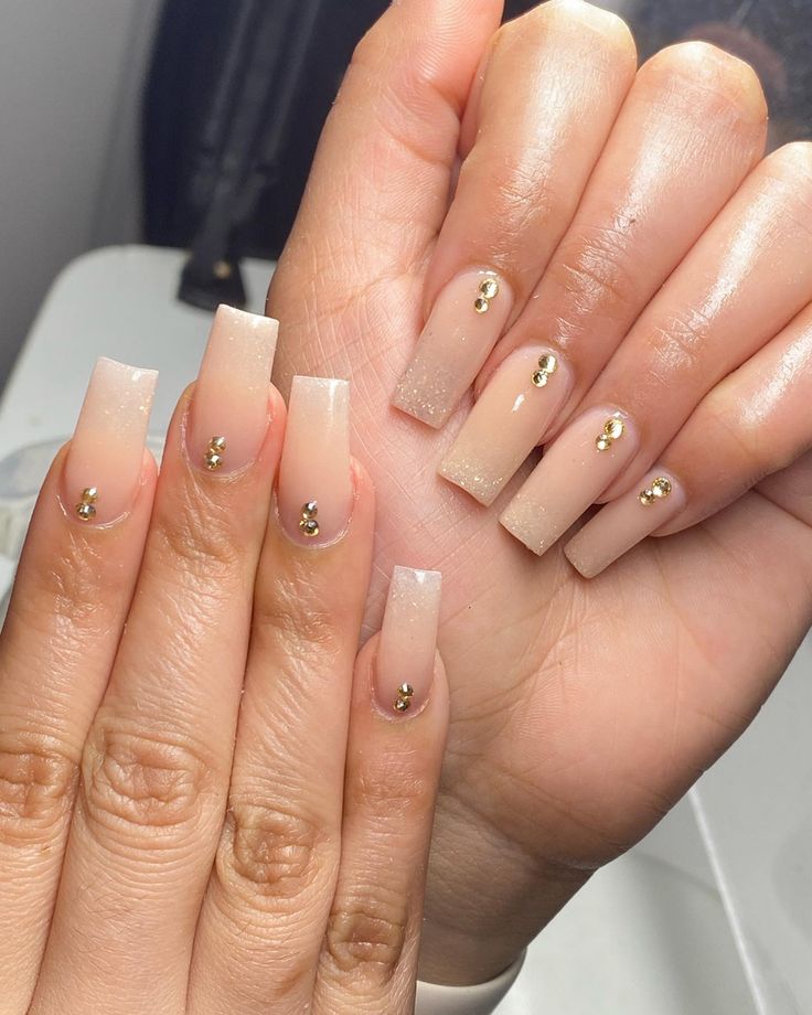 Sophisticated Nude Gradient Nail Design with Gold Accents for Any Occasion.