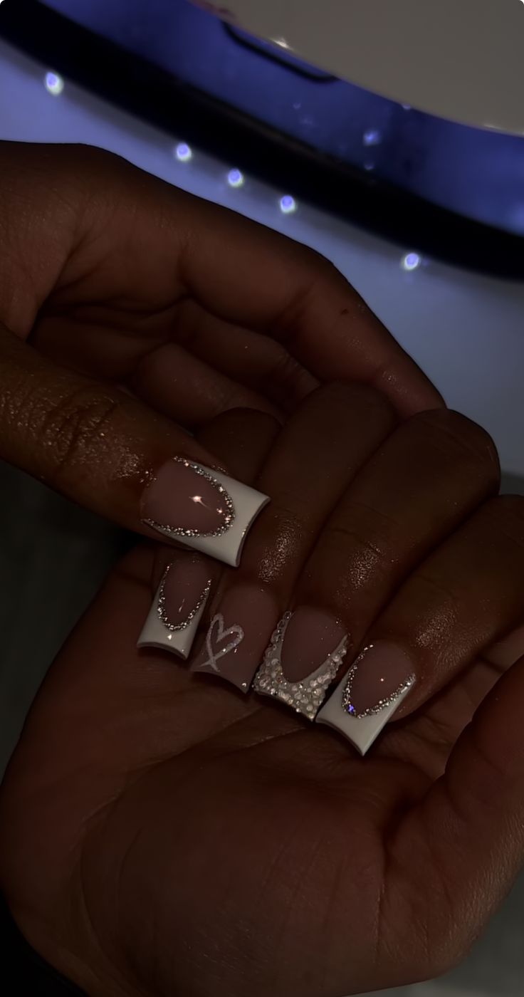 Chic Nude and White Geometric Nail Design with Glitter and Heart Motif.