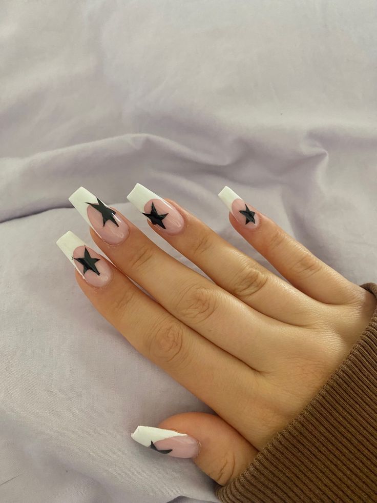 Chic Nail Design: Soft Pink and White Tips with Bold Black Stars