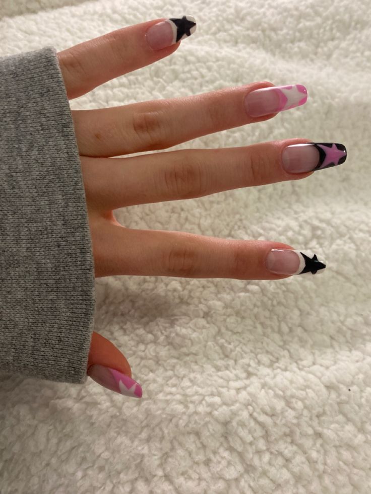 Trendy Nail Design: Soft Pink and Bold Black Accents with Playful Star Motifs