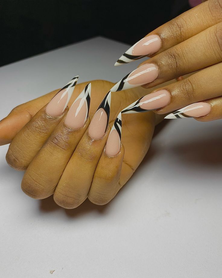 Elegant Almond-Shaped Nail Design: A Sophisticated Blend of Nude with Bold Black and White Patterns