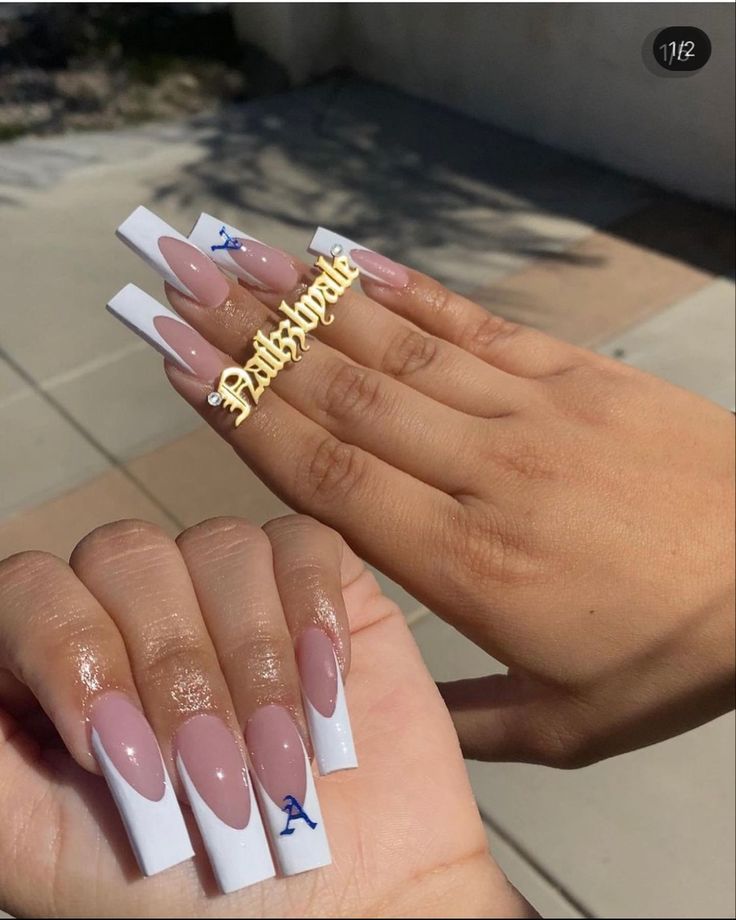 Bold and Playful Nail Design with Elongated Nude and White Tips.