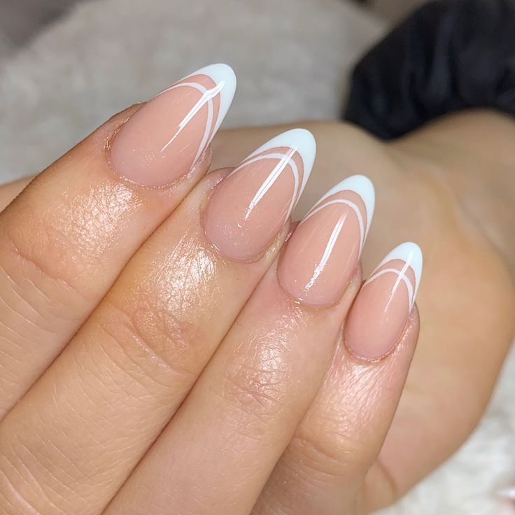 Chic Almond-Shaped Nails: Soft Nude Base with White Tips and Artistic Curves for Sophisticated Elegance.