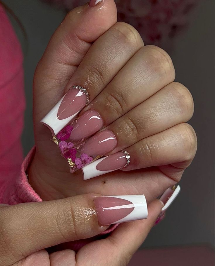 Charming Modern French Manicure with Pink and White Tips, Glitter Accents, and Rhinestone Artistry.