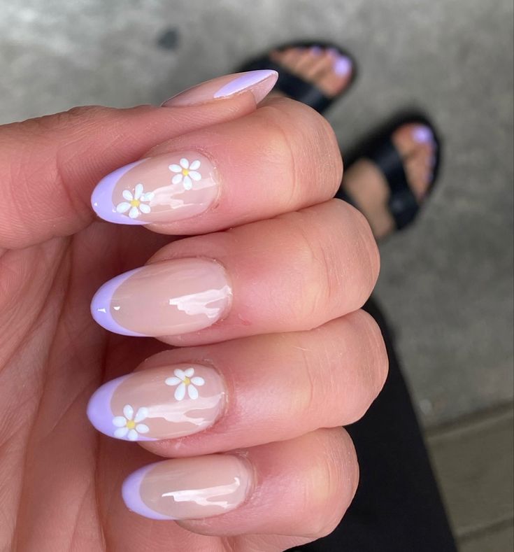 Charming Spring/Summer Nail Design: Soft Nude Base with Lilac Tips and Delicate White Flowers.