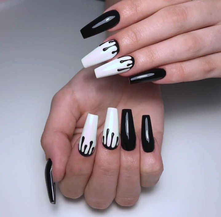 Bold Black and White Nail Design with Glossy Finish and Artistic Drip Details.