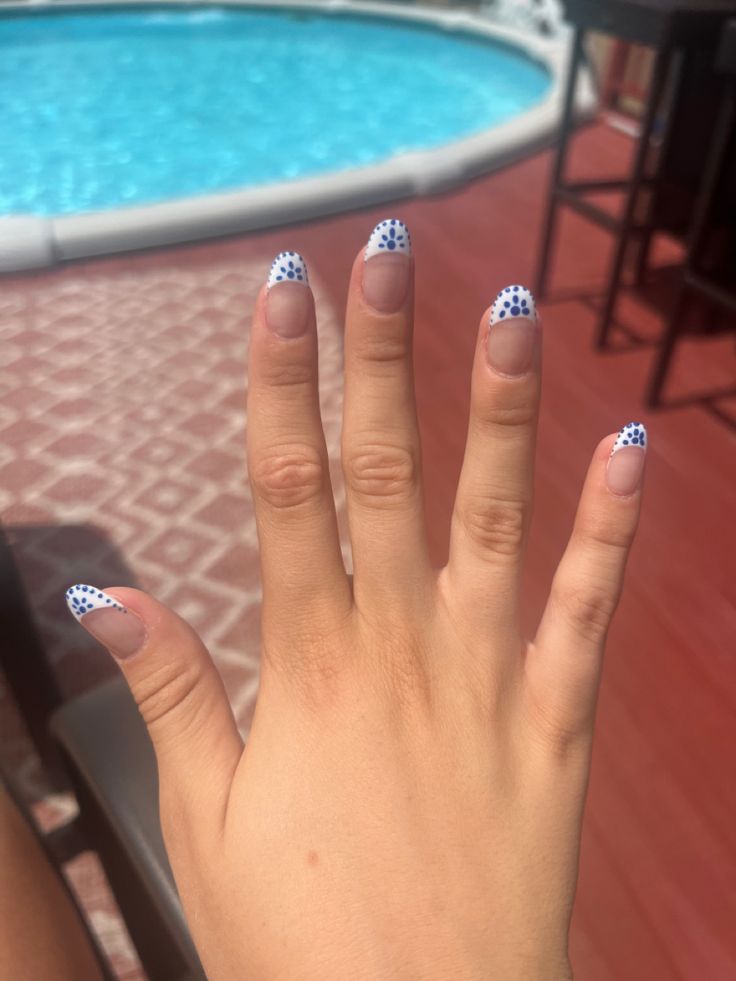 Chic Summer Nail Design: White French Tips with Playful Blue Polka Dots