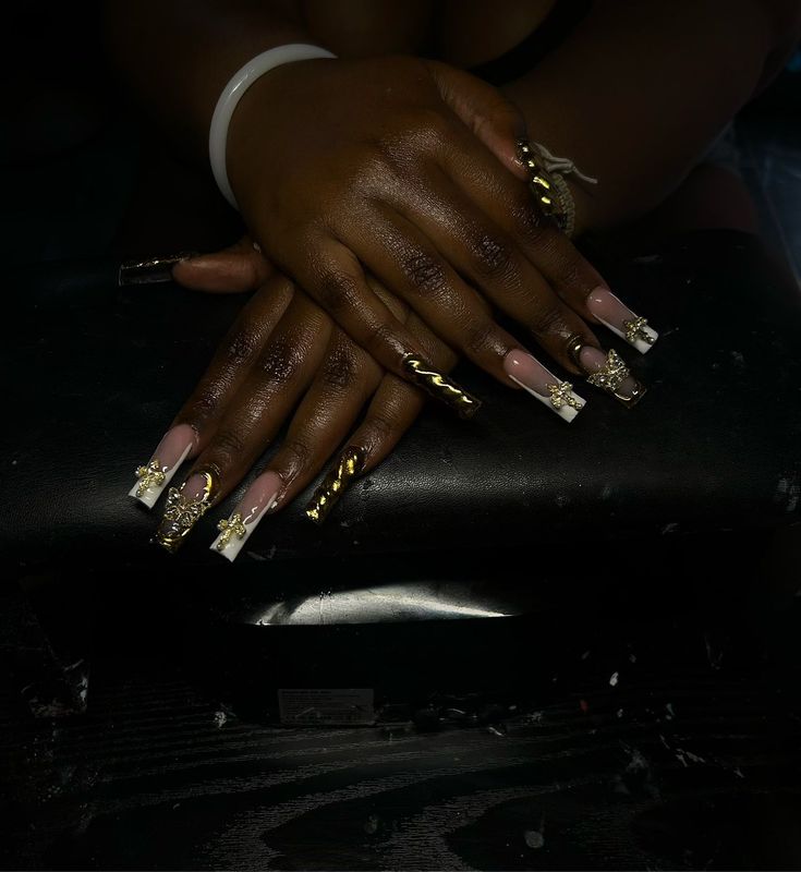 Elegant and Bold Intricate Nail Designs with Gold Accents and Floral Patterns.