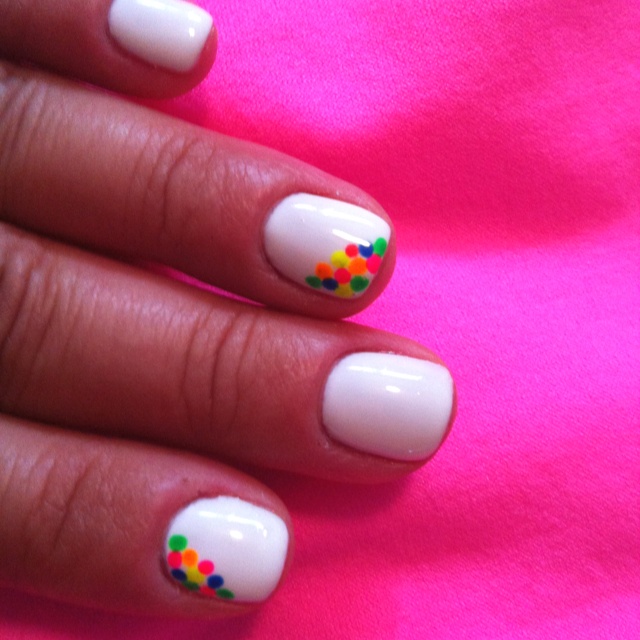 Playful Multicolored Dot Nail Design on Bright White Base for a Fun Summer Look.