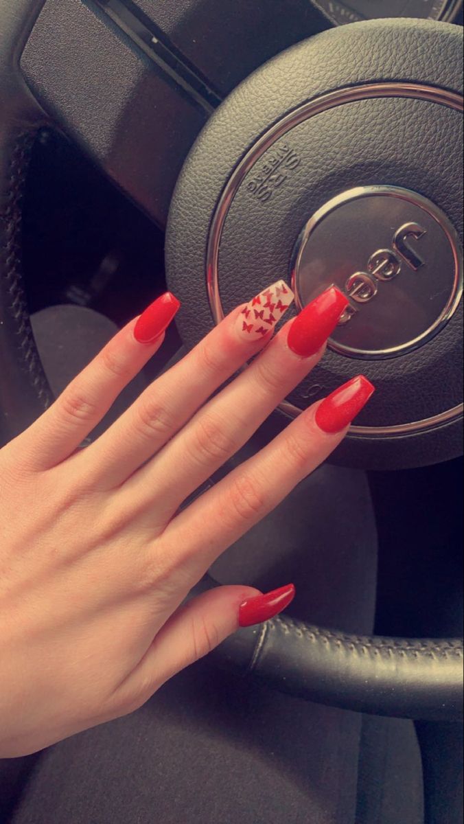 Bold Red Acrylic Nails with Unique Design Showcase Modern Nail Art Trends.