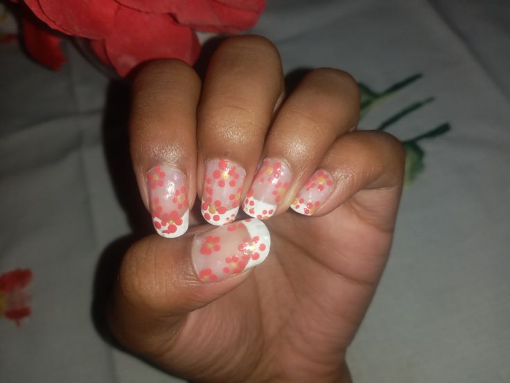 Charming Floral-Inspired Nail Design with Translucent Pink Base and Playful Polka Dots for Spring/Summer.