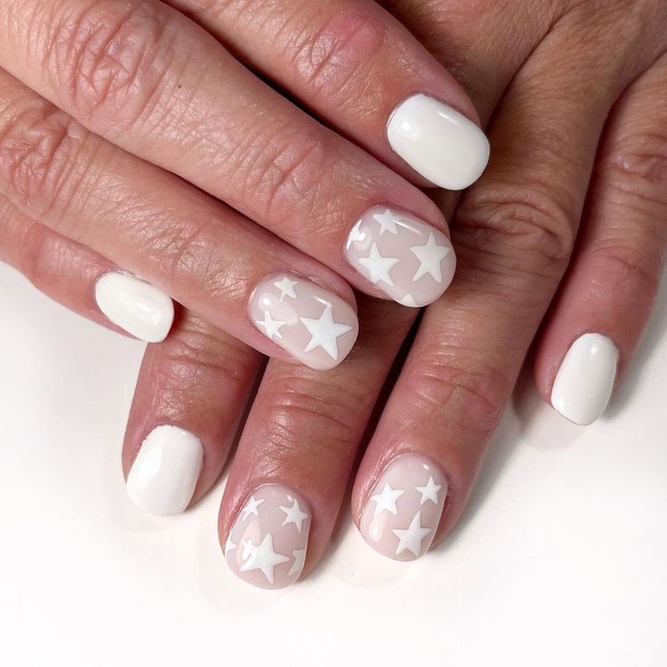 Elegant Chic Star-Patterned Nail Design with Glossy White and Soft Nude Tones.