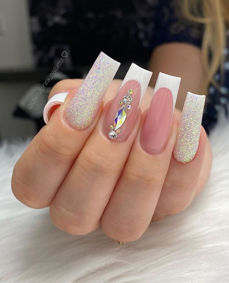 Chic French Tip Stiletto Nails with Glitter and Gemstone Accents for Glamorous Occasions.