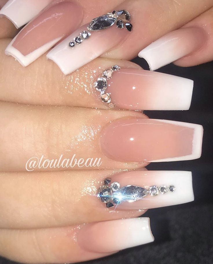 Sophisticated Gradient Nude and White Nail Design with Rhinestone Accents.